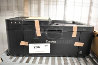 Canon TR4720 countertop printer, scanner, copier machine. Black model, 120 volts, 1 phase. Good condition with visible auction label.