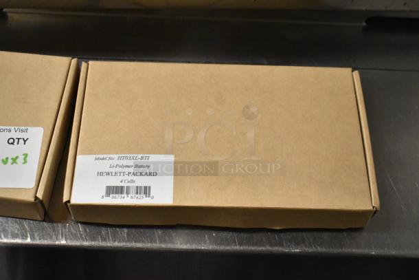Brown box labeled HT03XL-BTI Li-Polymer Battery by Hewlett-Packard, 4 cells. Includes 2 batteries and Fargo DTC color ribbon.