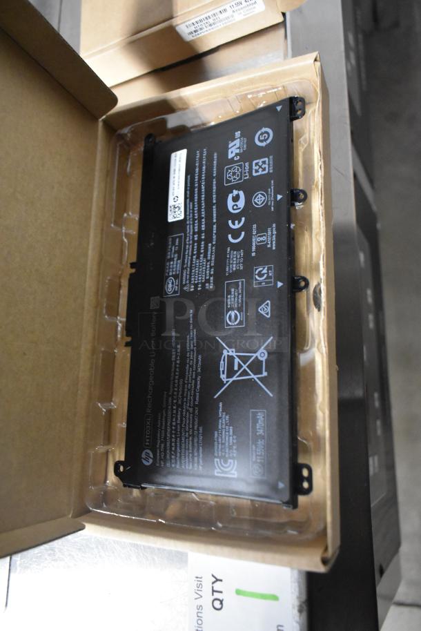 3 items: 2 HT03XL-BTI Li Polymer Batteries, 1 Fargo DTC Color Ribbon. Batteries in original packaging, labeled with specs.