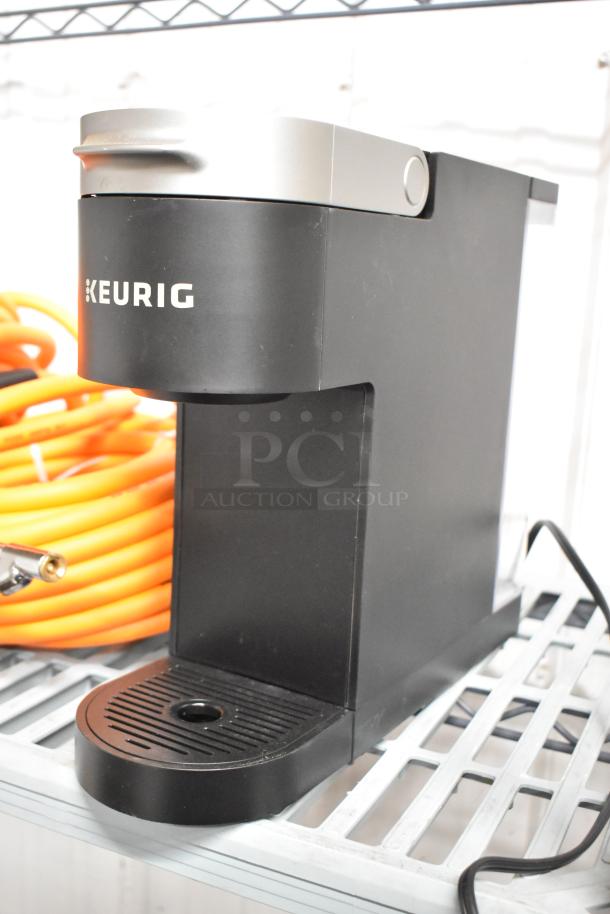 Keurig K900 countertop single cup coffee machine, 120V, 1 phase. Black, compact design, visible branding on front.