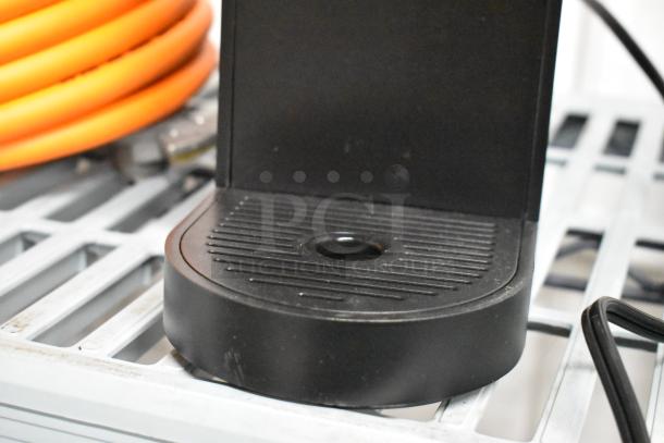 Keurig K900 single cup coffee machine, black base, 120V, for countertop use. Clean condition, visible cord.