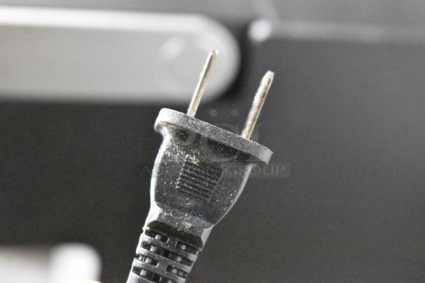 Close-up of a plug for a Keurig K Slim single cup coffee machine, 120 volts, 1 phase.