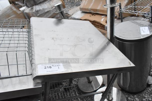 Stainless steel table with wire under shelf, featuring a flat top. Visible label: "For More Great Auctions Visit PCIAuctions.com".