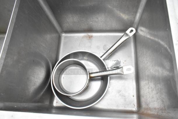 Commercial 3 bay sink with dual pans inside. Stainless steel construction. Equipped with faucet and handles. Good condition.