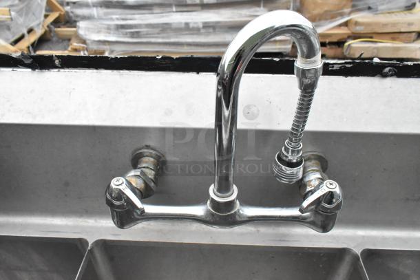 Commercial stainless steel 3 bay sink with chrome faucet and dual handles, suitable for high-volume kitchen use.