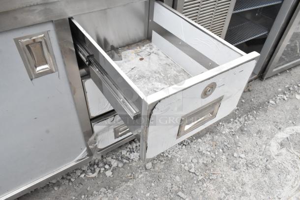 Regency 600EBT3060 enclosed base table with sliding doors and drawers, stainless steel, visible wear, ideal for storage.