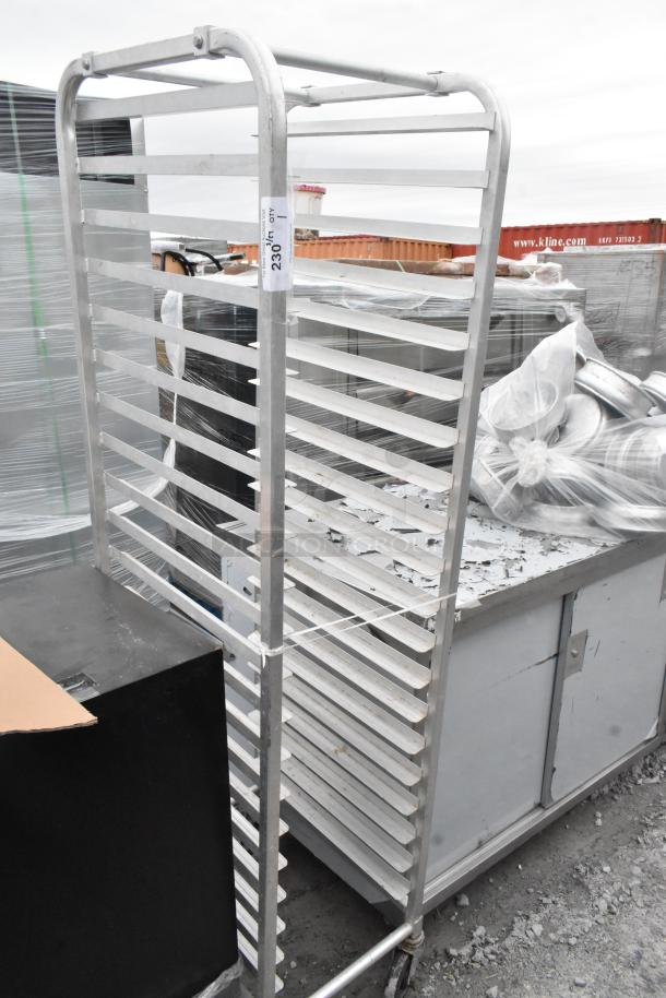 Commercial pan transport rack with multiple shelves on sturdy casters. Used condition, label shows "2361". Rugged design.