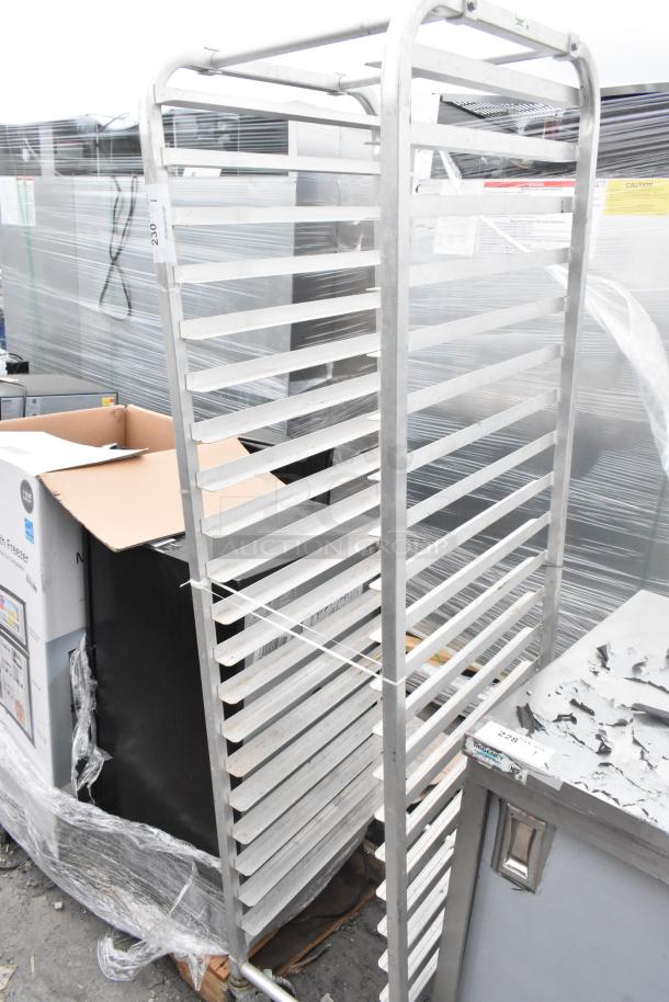 Commercial pan transport rack with multiple shelves on commercial casters, metal construction, good condition.