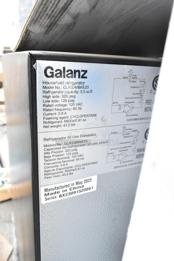 Galanz GLR33MBKE23 mini cooler, 3.3 cu. ft, 120V, 1 phase. Label shows specs and "Manufactured in May 2023, Made in China."