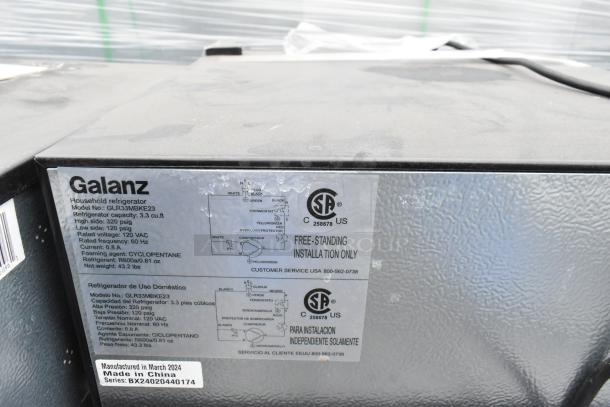 Galanz refrigerator model GLR33MBKE23 tag shows specs: 3.3 cu.ft, 120V, 60Hz, 0.8A. Manufactured in March 2024, Made in China.