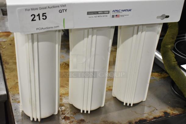 Apec Water WFS-1000 water filtration system with three white filter housings and model label; appears in good condition.