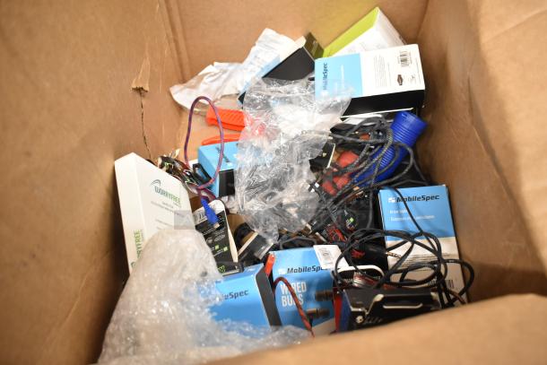 Box of 62 items including Uniden Pro505XL radio, Rove and MobileSpec earbuds, and USB cables. Mixed condition.