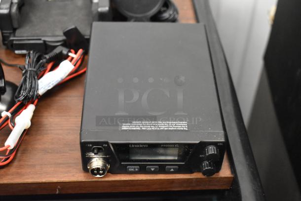 Uniden Pro505XL radio, black, with control knobs and display, in good condition, includes wiring bundle.