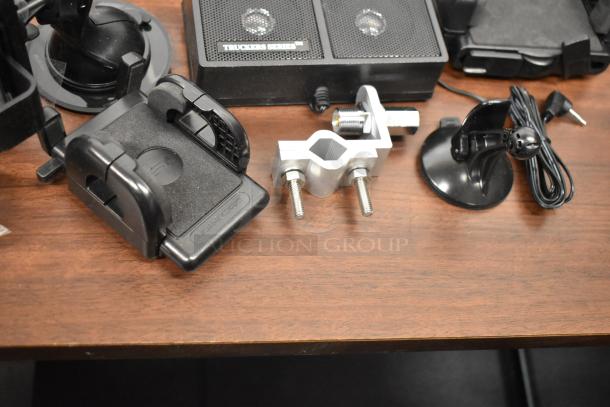 Various electronic accessories including mounts, clamps, and cords on a table, featuring Truckers Series radio.