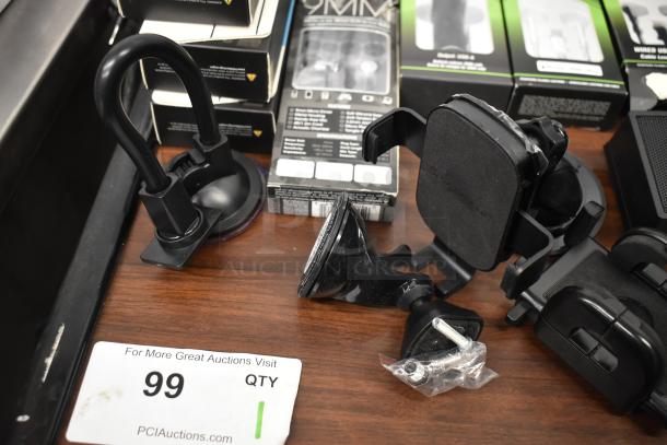 Assorted electronics including Uniden Pro505XL radio, wired earbuds, phone mounts, and micro USB cables on a wooden surface.