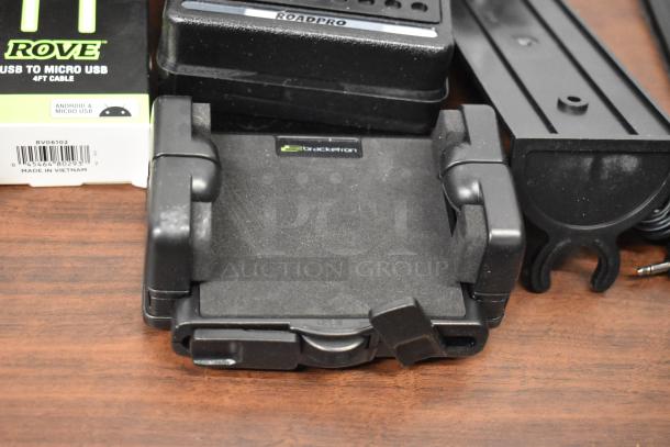 62-item lot with Uniden Pro505XL radio, Rove earbuds, MobileSpec buds, and PremierSeries USB cable. Mix of tech gear.