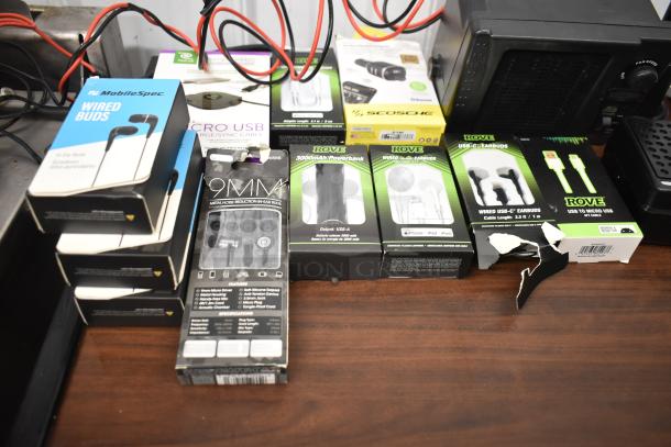 Assorted electronics including Uniden Pro505XL radio, Rove earbuds, MobileSpec buds, PremierSeries USB cables; 62 items.