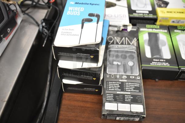 Assorted electronics auction items featuring MobileSpec wired earbuds, charging cables, and power banks.