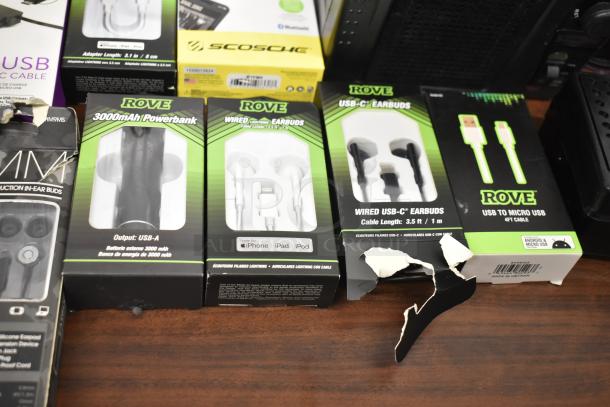 Assorted electronic accessories, including Rove earbuds, power bank, USB cables, and more. Packaging shows product details.
