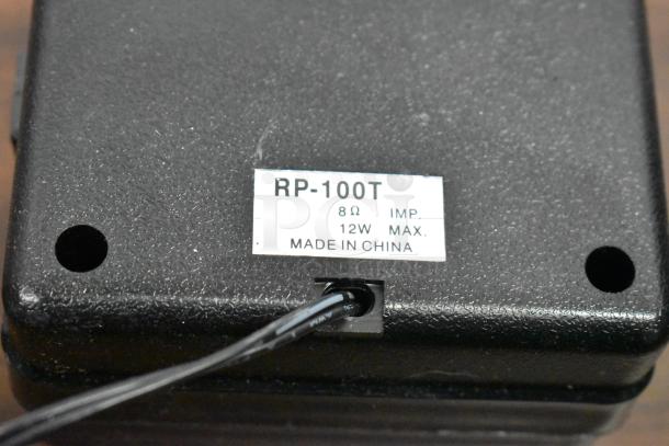 Black device with label "RP-100T, 8Ω, 12W MAX, Made in China." Part of an auction lot with various electronics.