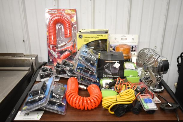 Assorted 25-item lot featuring a fan, RoadKing USB charger, MobileSpec adapter, PowerDrive cup adapter, and more, in new packaging.