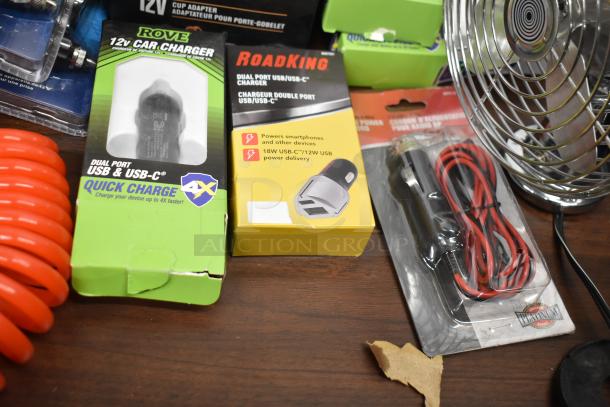 Auction lot of 25 items includes a fan, RoadKing USB charger, MobileSpec adapter, PowerDrive cup adapter, Rove car charger, RoadPro strobe light, GE halogen headlamp, and heavy-duty duster gun.