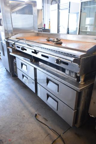 American Range commercial countertop flat top griddle on 4-drawer chef base. Stainless steel, used condition, visible wear.