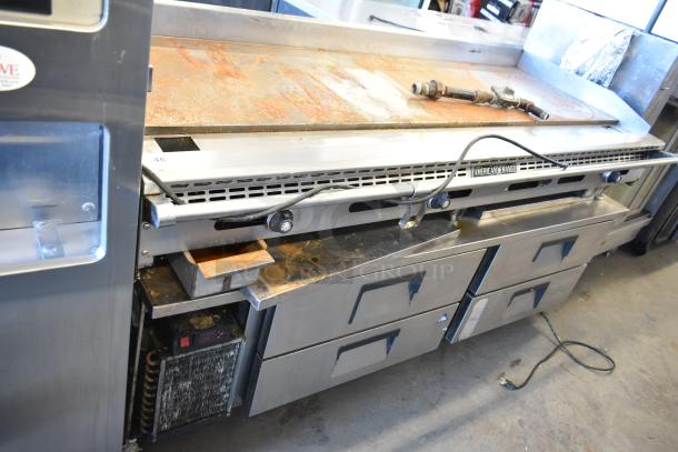 American Range commercial countertop flat top griddle on a 4-drawer chef base. Shows rust and wear. Brand label visible.