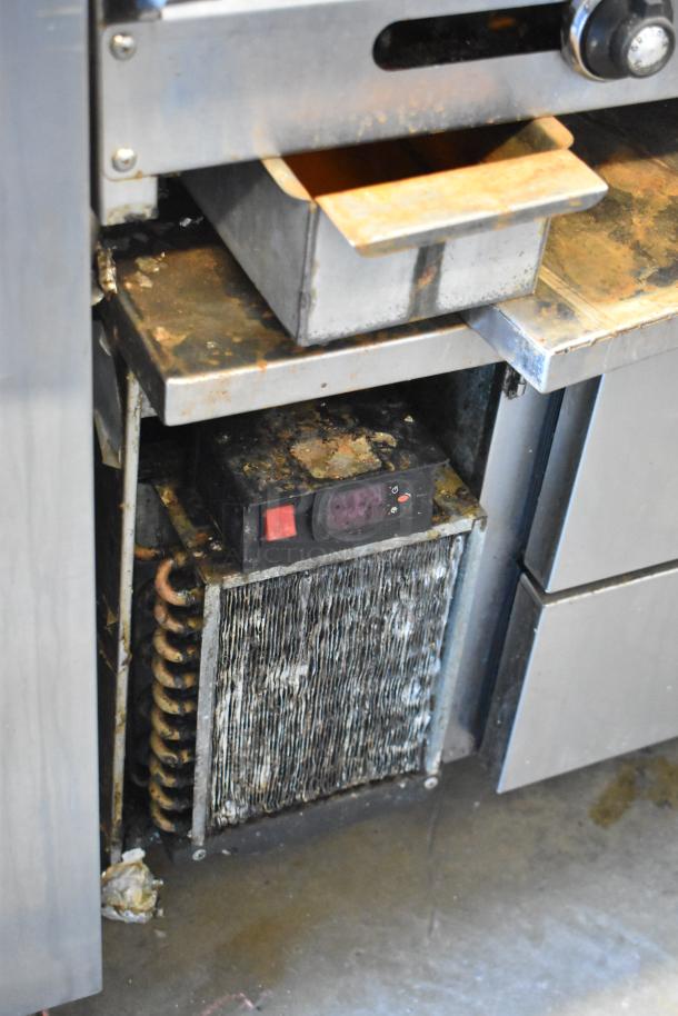 American Range commercial griddle on 4-drawer chef base, visible wear and rust, built-in control panel.