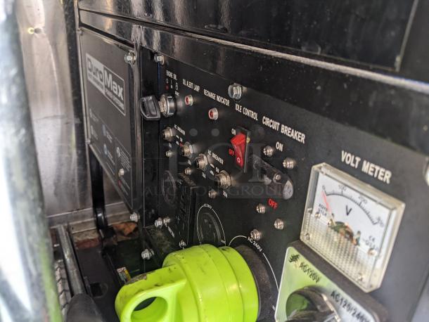 Control panel of 2002 Freightliner MT45 food truck, featuring DuroMax power system, voltage meter, circuit breaker, and indicator lights.