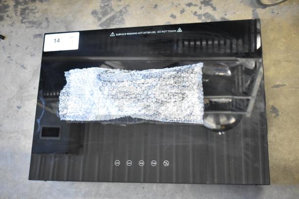 Brand new 2025 Avantco 177ICW375 16" x 23" black induction warmer. Features power settings, warning labels. 120V, 1-phase.