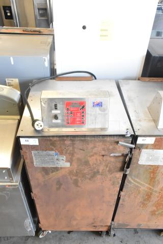 Cookshack 250 commercial electric smoker, on casters, 208 volts, 1 phase. Rusty exterior, visible control panel and labels.