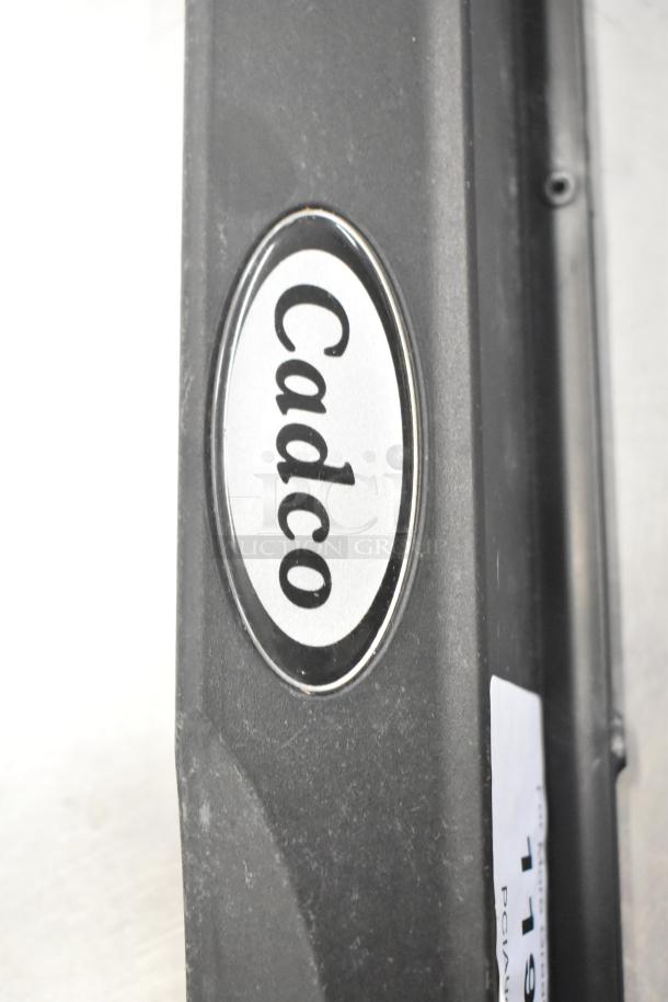 Cadco branded black item with visible label. Part of auction lot of 20 new items including ballasts and blower wheel.