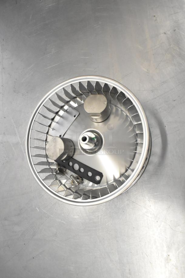 Brand new Cadco/Unox blower wheel on metal surface. Features include metal construction and pristine condition.