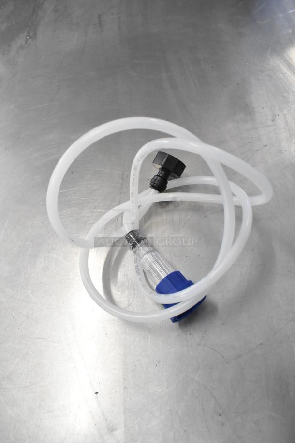 Brand new Cadco/Unox component with tubing and connectors on metal surface. Ideal for technical setups.