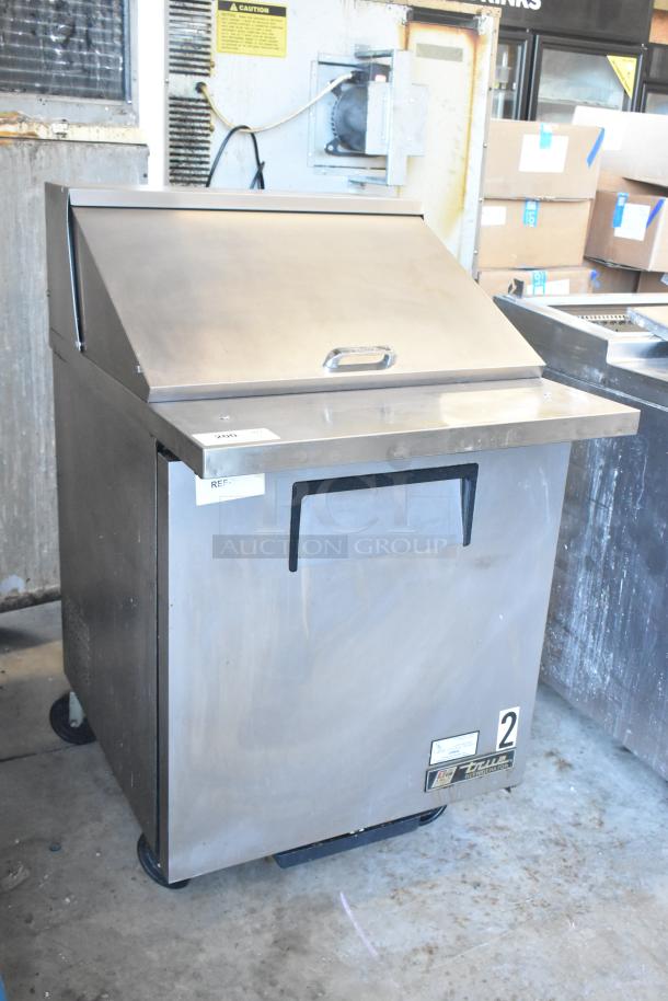 True TSSU-27-12M-B sandwich prep table on casters. Stainless steel, excellent condition, 115V, 1 phase, visible label.