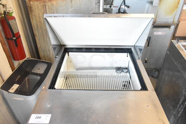 True TSSU-27-12M-B commercial sandwich salad prep table, bain marie top, 115 volts, on casters, model label visible.