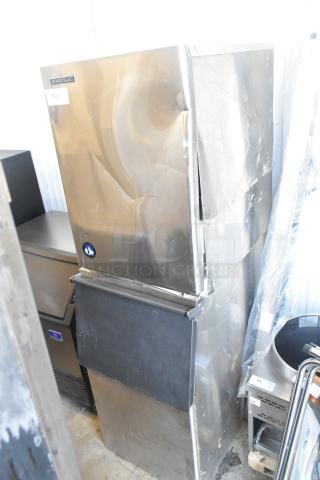 Hoshizaki KM-501MWH ice machine head on bin, 115-120V, 1 phase. Visible dents on stainless steel front.
