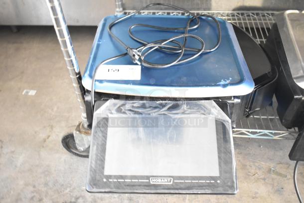 2024 Hobart HTi-7LH4W commercial countertop scale, blue top, cords visible, tested but not powering on.