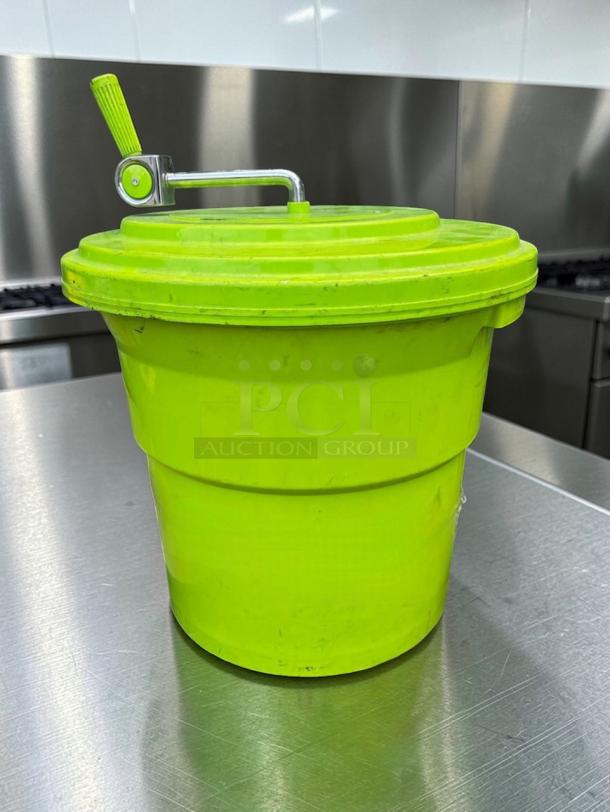 Manual commercial salad spinner, vibrant green, large capacity, heavy-duty plastic with handle, ideal for food prep.
