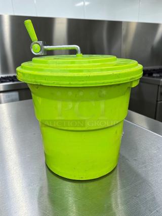 Manual commercial salad spinner, vibrant green, large capacity, heavy-duty plastic with handle, ideal for food prep.