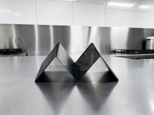 Stainless steel taco holder in prime condition, ideal for commercial use. Model TAC-S-HLD-0672, set of 35.