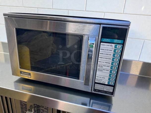 Sharp R-22GT commercial microwave, 1200W, stainless steel, superior condition; model label visible.