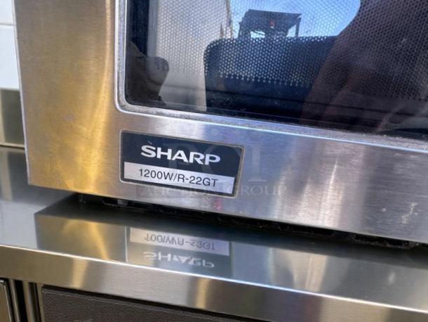 Sharp R-22GT commercial microwave, 1200W, stainless steel, excellent condition, tested and operational, model label shown.