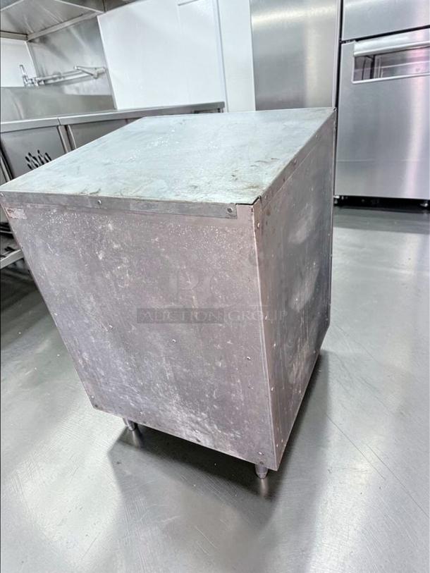Commercial stainless steel equipment stand in excellent condition, with open shelf storage, heavy-duty, ready for kitchen use.