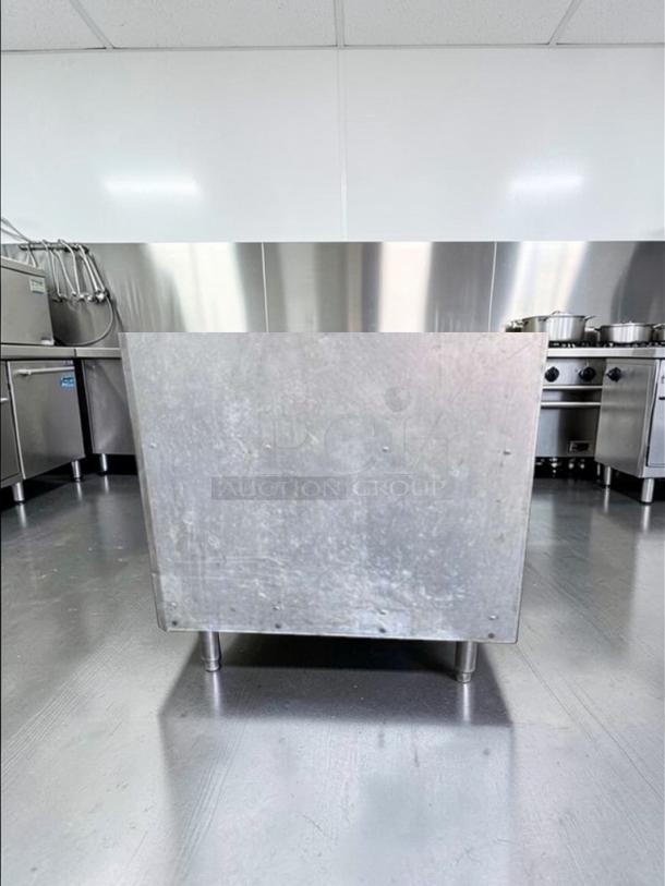 Commercial stainless steel equipment stand with open shelf, heavy-duty construction, Excellent condition, model COM-S-STD-0687.