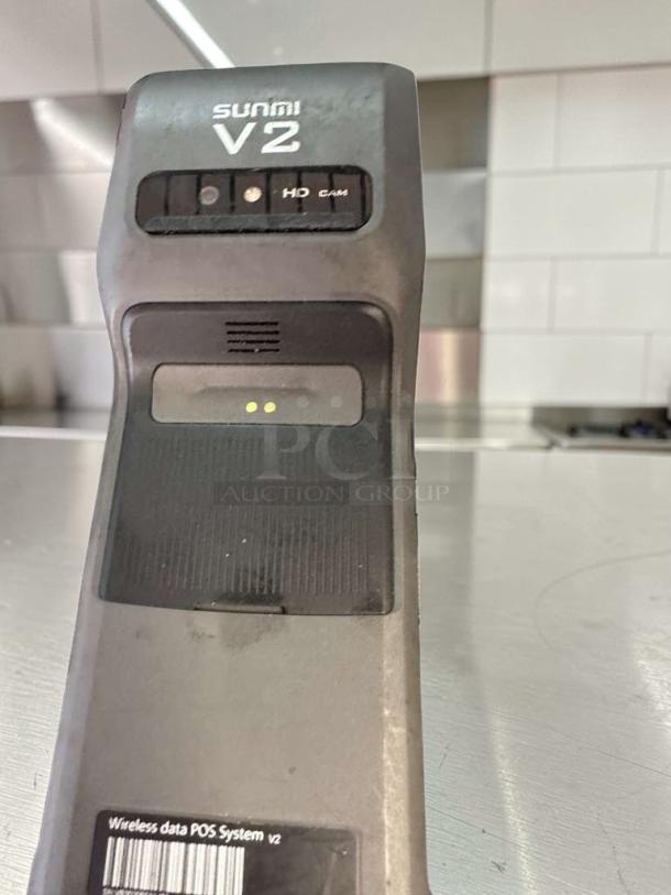 Sunmi V2 wireless POS terminal in outstanding condition, with built-in receipt printer and visible labels, model V2.