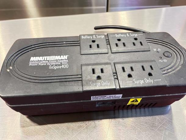 Minuteman EnSpire 400 UPS Battery Backup, 400VA, 6 outlets, black, high-quality condition, labeled "Battery & Surge."
