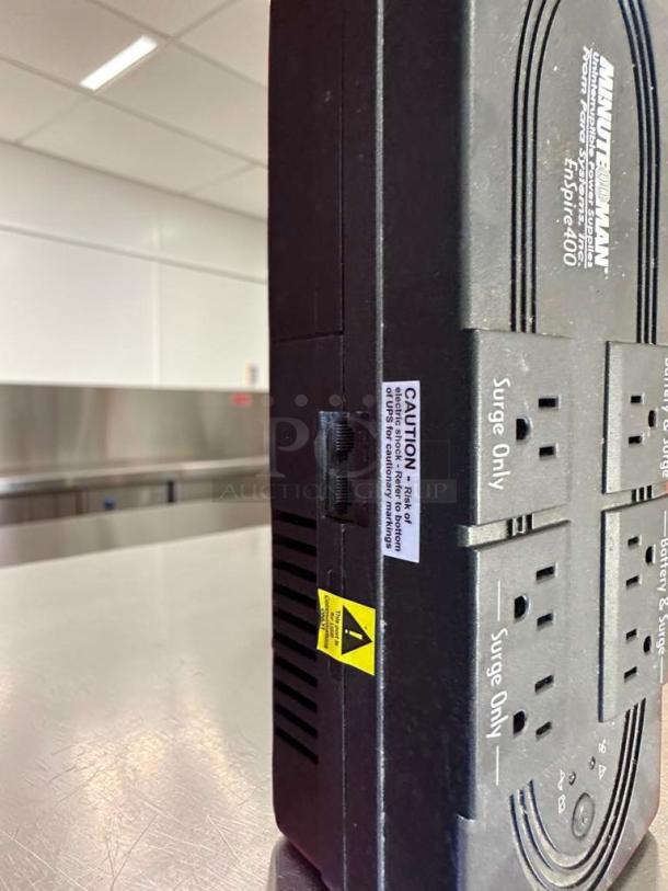 Minuteman EnSpire 400 UPS Battery Backup with 6 outlets, high-quality condition, visible caution labels, model details.