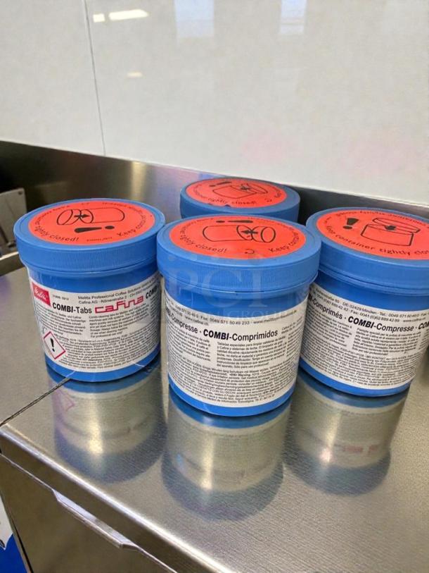 Set of 4 Melitta COMBI-Tabs coffee machine cleaning tablets, blue containers with red lids, for Melitta & Cafina systems.